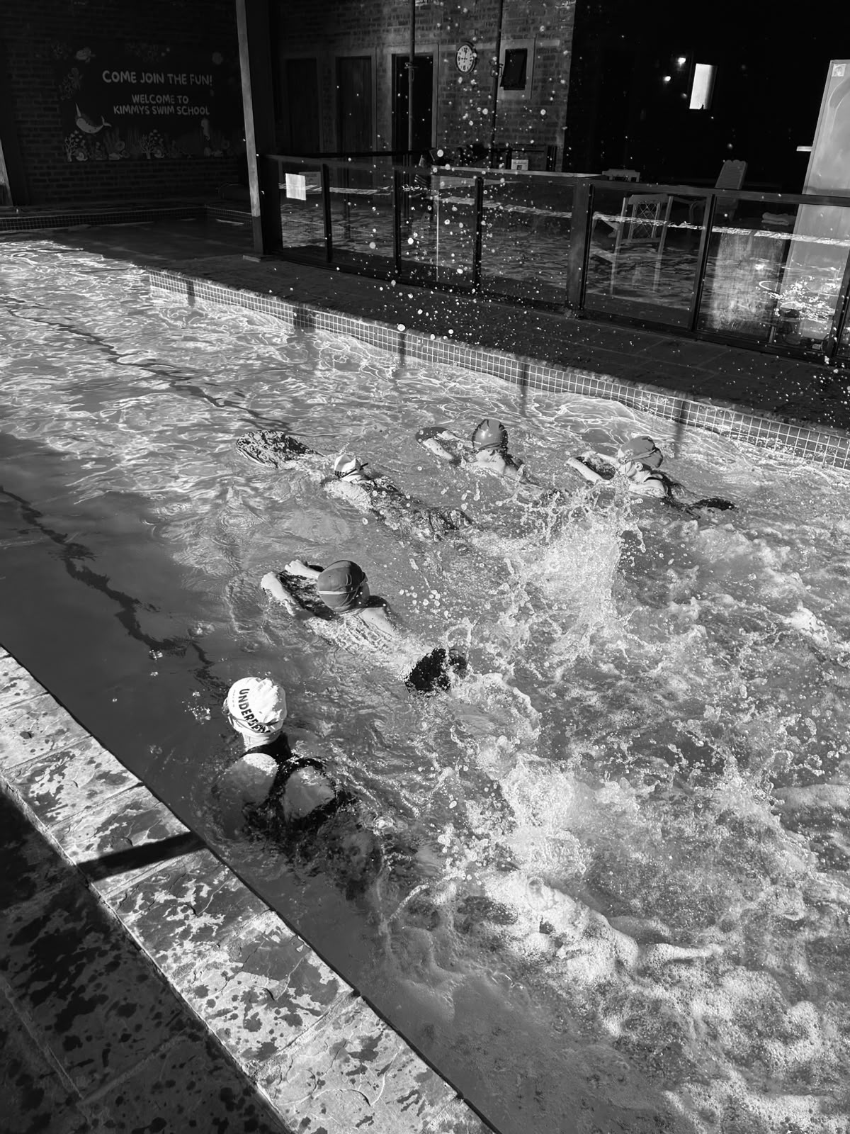 Black and white shot of squad swimmers training