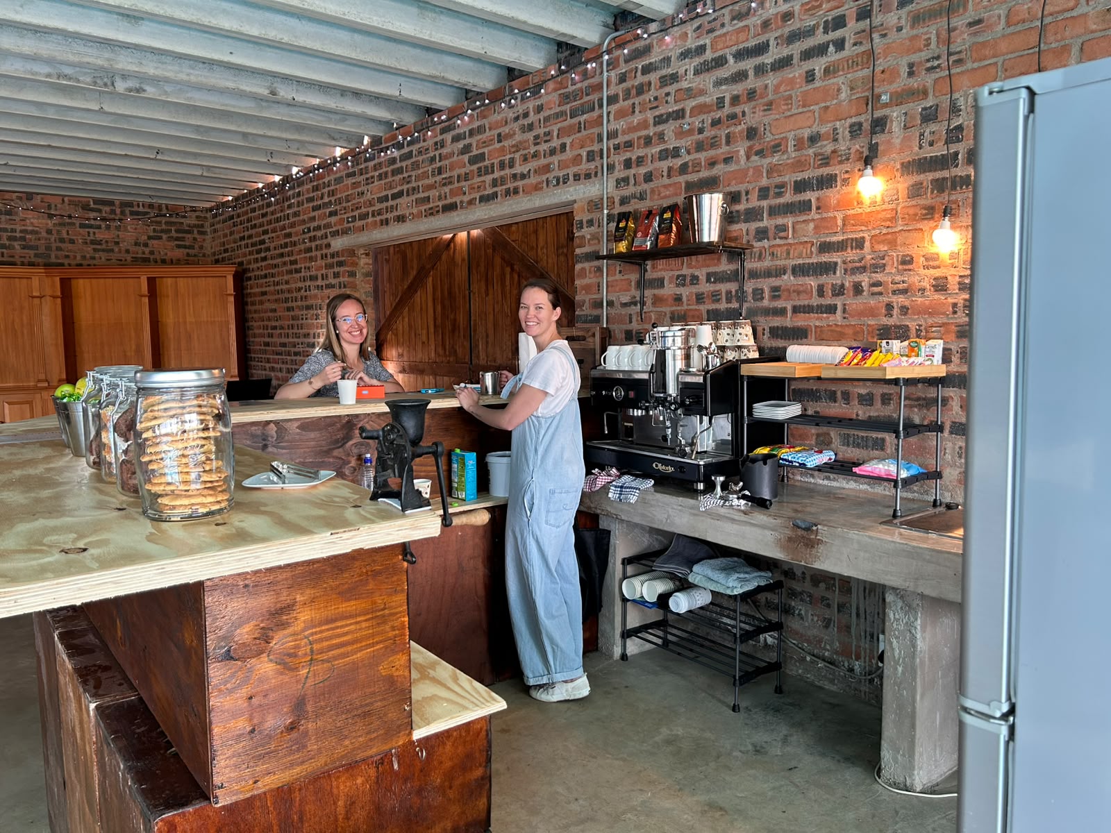 Kimmy's café counter with barista and espresso machine