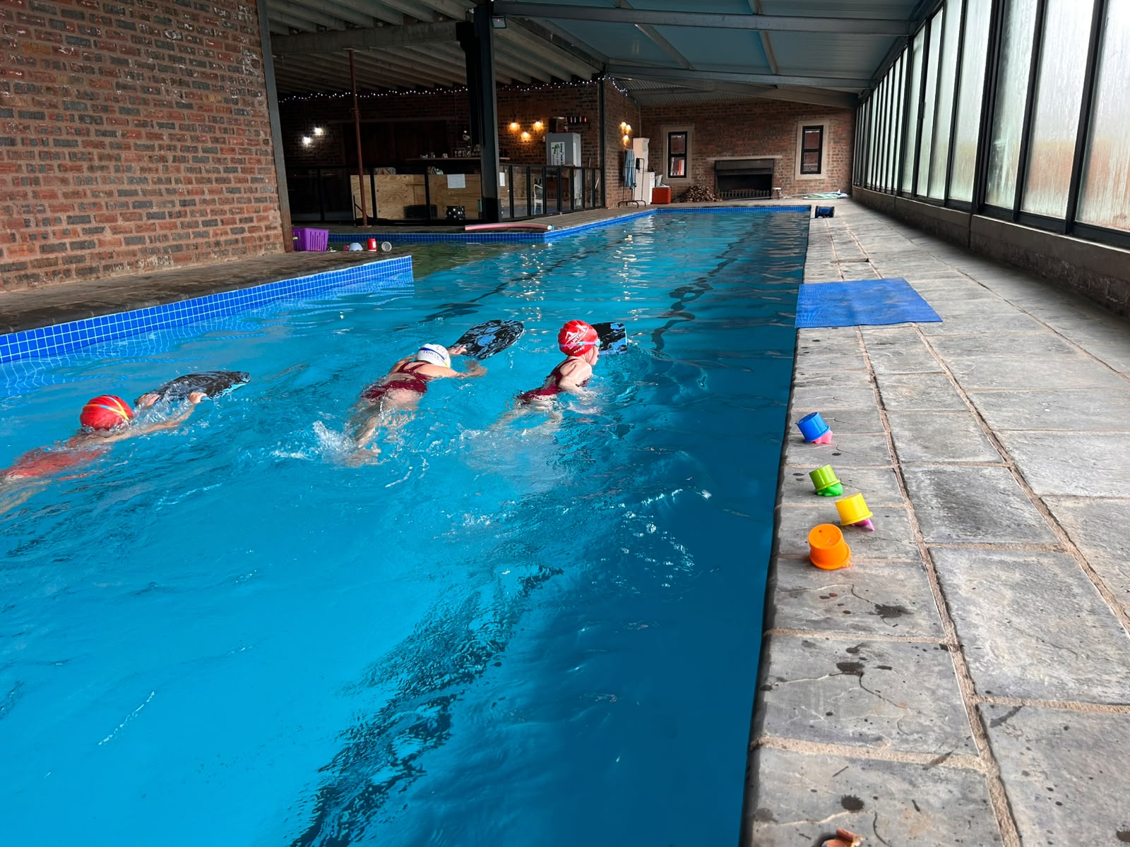 Junior swimmers streamlining down the lane